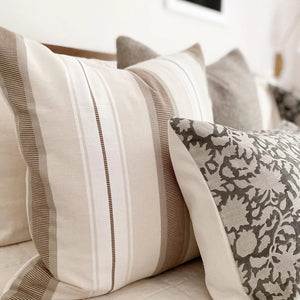 Closeup of Charles pillow cover from Colin and Finn with ivory, taupe, and brown vertical stripes.