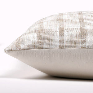 Side view of Darby pillow cover with taupe and white checkered front textile and ivory backing on a white backdrop.