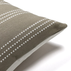 Corner of the Darcy pillow showing the handwoven ivory stripe detailing