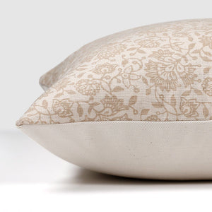 Side view of Delilah pillow cover showing beige floral motif on front and solid ivory backing.
