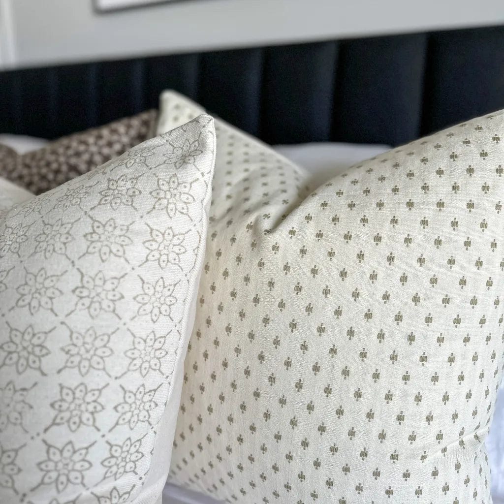 Closeup of Elodie pillow cover showing the taupe embroidered detailing.