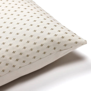 Closeup of Colin and Finn's Elodie pillow cover, showing the ivory background with embroidered taupe stitching.
