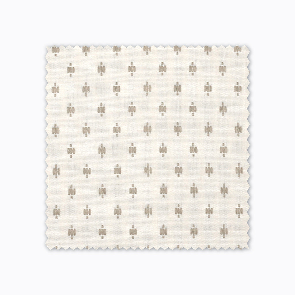 Elodie fabric swatch from Colin and Finn. Small gold crosses on a cream background