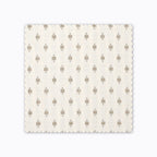 Elodie fabric swatch from Colin and Finn. Small gold crosses on a cream background