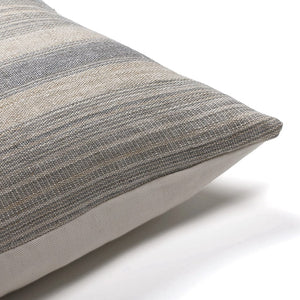 Corner of the Felicity pillow cover showing the gray handwoven stripe detail and the ivory backing
