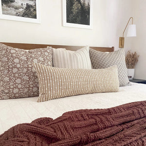 Gideon pillow combination with Eleanor natural, Oscar, Ella, and Bardot lumbar pillow covers with white bedding and maroon throw blanket.