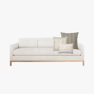Mocked up photo of a cream sofa with the Hawthorn pillow combination on the right side.