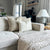Kinsey, Neville in Sand, and Elodie lumbar pillow covers on a gray sectional with chunky taupe blanket.