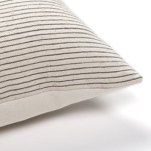 Corner of Laney lumbar pillow cover from Colin and Finn that's ivory with vertical charcoal stripes