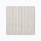 Laney fabric swatch from Colin and Finn. A charcoal stripe on handwoven ivory linen.