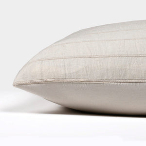 Side view of the Logan pillow cover from Colin and Finn showing the ivory cotton stripes on the front and the solid ivory backing on the back.