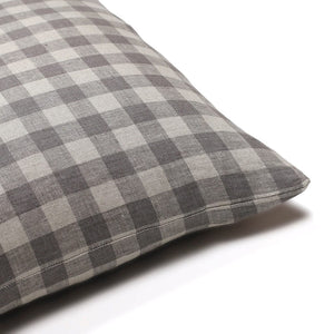 Corner of Colin and Finn's Maxwell pillow cover showing the gray, blue large-print gingham print on the front and back.