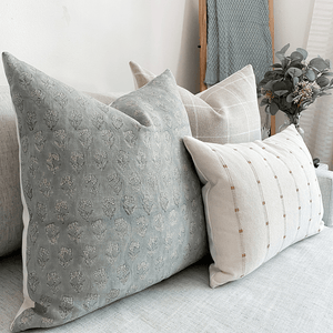 Close-up of Naples Pillow Combination on white sofa.
