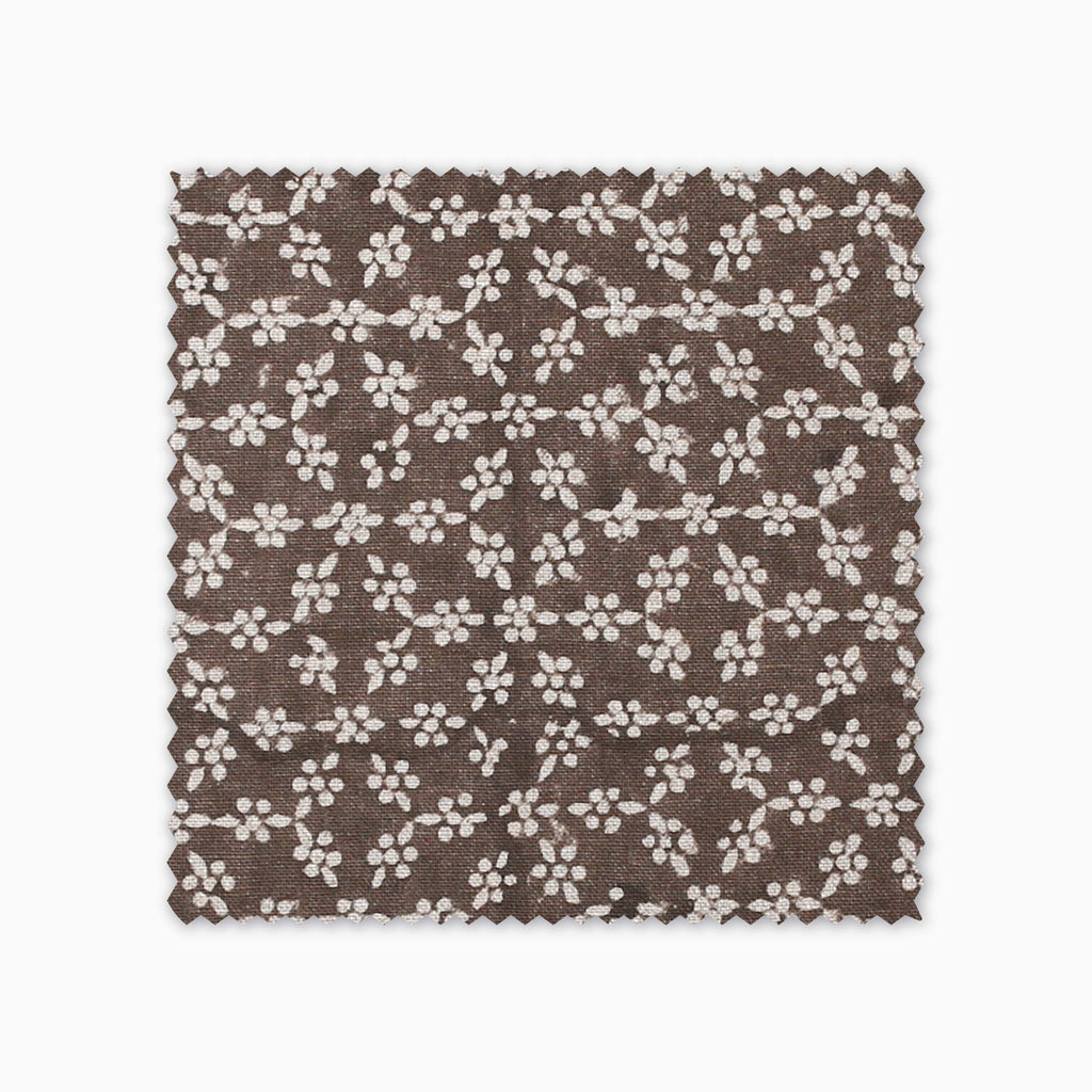 Neville Mocha fabric swatch from Colin and Finn. Cream flowers on a brown background