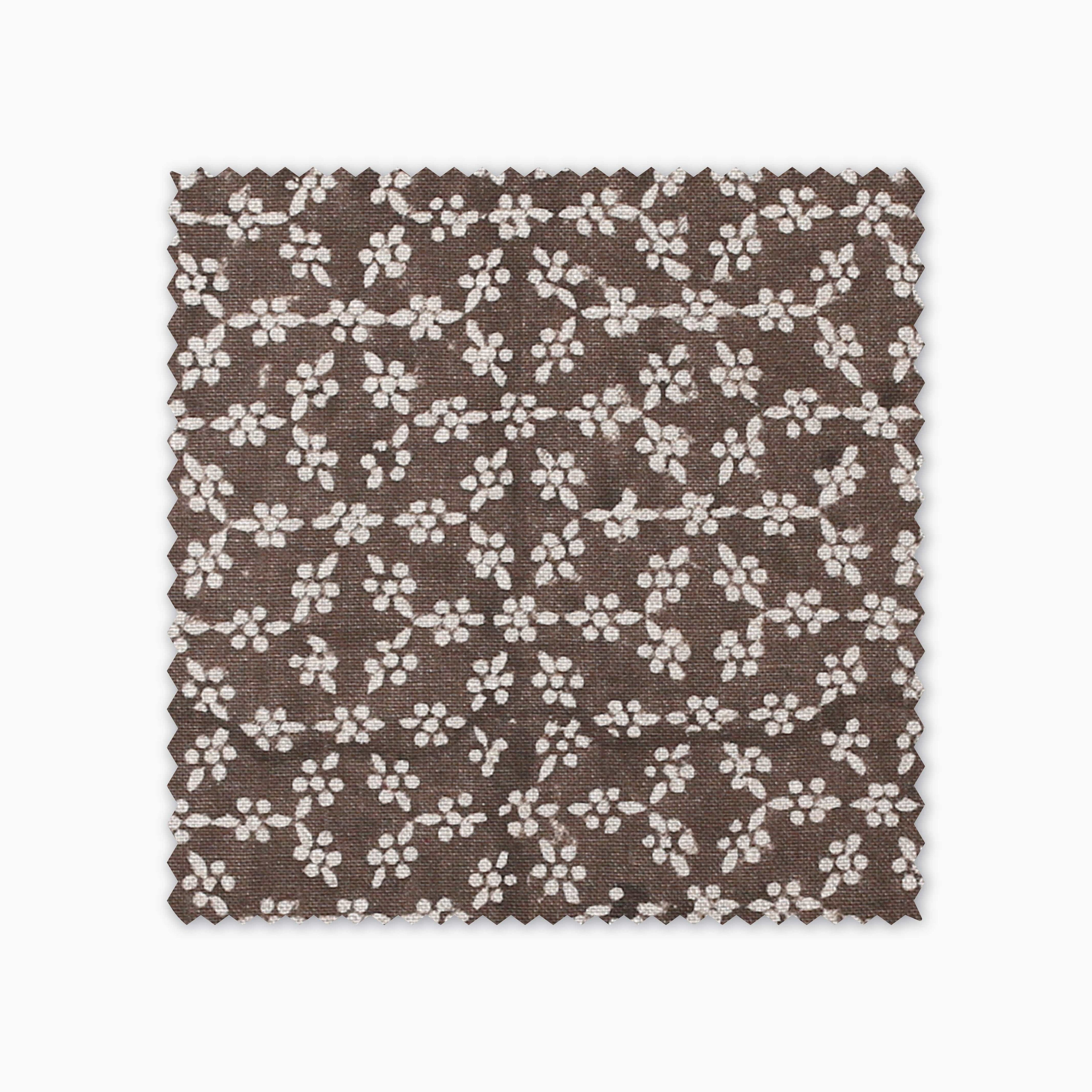 Neville Mocha fabric swatch from Colin and Finn. Cream flowers on a brown background