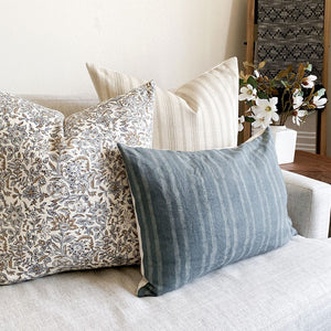 Oscar, Penelope, and River lumbar pillow covers from Colin and Finn on white sofa with floral arrangement on side table.