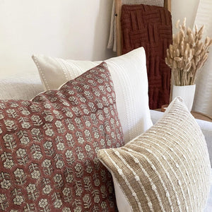 Sadie, Serena, and Bardot lumbar pillow covers from Colin and Finn with maroon throw blanket on ladder.