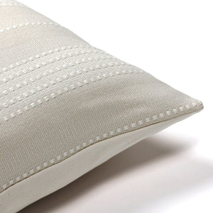 Corner of the Sadie pillow cover showing the white handwoven stripe details
