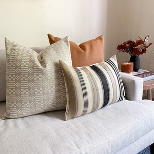Sloane, Nissa, and Benedict lumbar pillow covers on a cream sofa with florals on the side table.