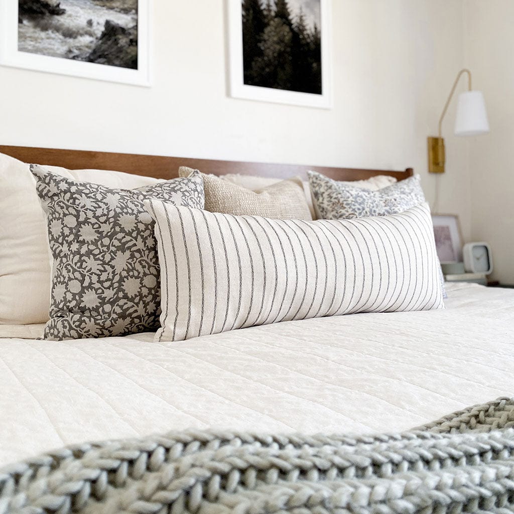 Stella Pillow Combination from Colin and Finn including Sawyer, Weston, Penelope, and Winston oversized lumbar pillow cover on cream quilted bed.