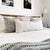 Stella Pillow Combination from Colin and Finn including Sawyer, Weston, Penelope, and Winston oversized lumbar pillow cover on cream quilted bed.