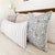 Penelope and Winston long lumbar on a white bed with wood headboard.