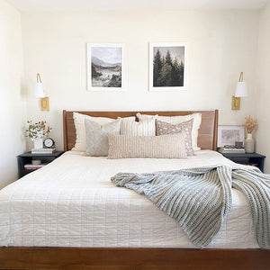 Vivi pillow combination from Colin and Finn featuring Avery, Oscar, Emma natural, and Bardot oversized lumbar pillow cover on white bedding with wood headboard and sage green throw blanket.