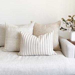 Weston, Luella, Winston lumbar pillow covers from Colin and Finn on white sofa with floral arrangement on side table.