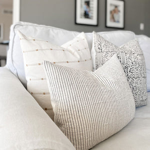 Side view of Colin and Finn's Greyson pillow combination showing front textiles of Rory, Madison, and Laney lumbar with their ivory backing.